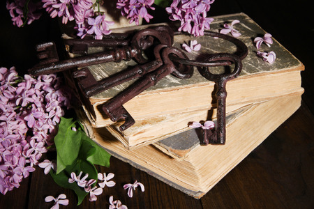 Beautiful composition with old keys and old books on wooden backgroundの写真素材