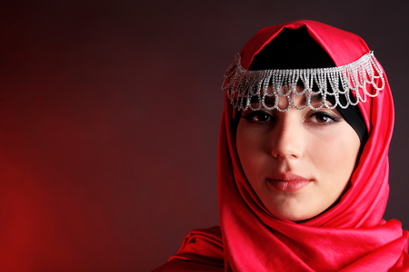 Beautiful muslim arabic woman on dark color backgroundの写真素材