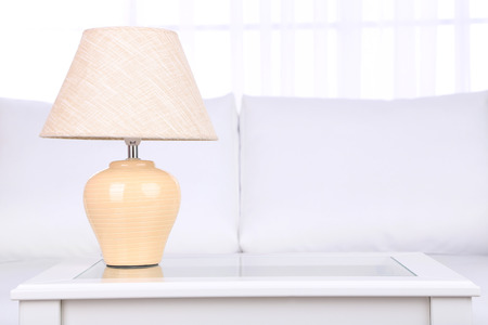 Lamp on coffee table in roomの写真素材