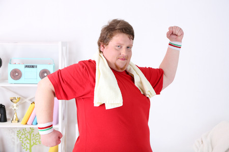 Large fitness man working out  at homeの写真素材