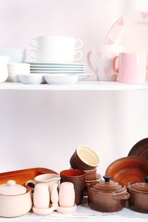 Different tableware on shelf, isolated on whiteの写真素材