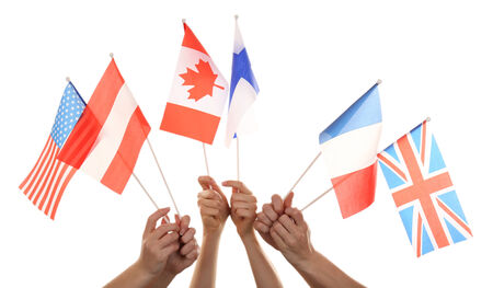 Hands holding different flags, isolated on whiteの写真素材