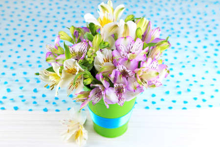 Bouquet of freesias in pail on table close-upの写真素材