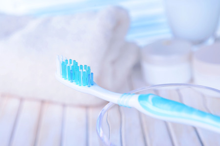 Toothbrush in glass on table on light backgroundの写真素材