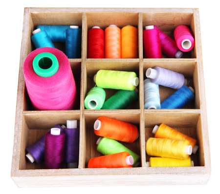 Multicolor sewing threads in box isolated on whiteの写真素材