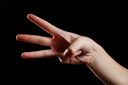 Human hand on black background