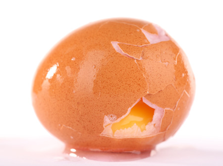 Broken egg isolated on whiteの写真素材