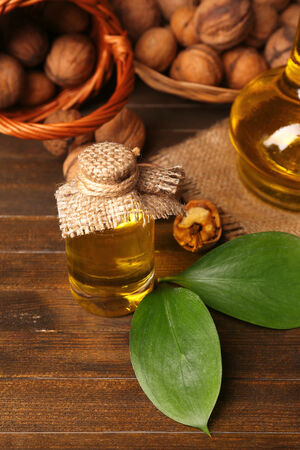 Walnut oil and nuts on wooden tableの写真素材
