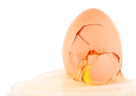 Broken egg isolated on whiteの写真素材