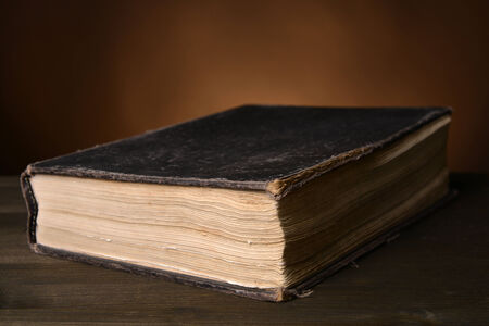Old book on table on brown backgroundの写真素材