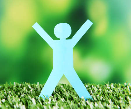 Paper people on green grass, close upの写真素材