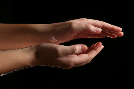 Human hands on black backgroundの写真素材