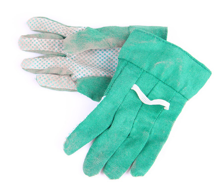 Dirty used fabric gloves isolated on whiteの写真素材