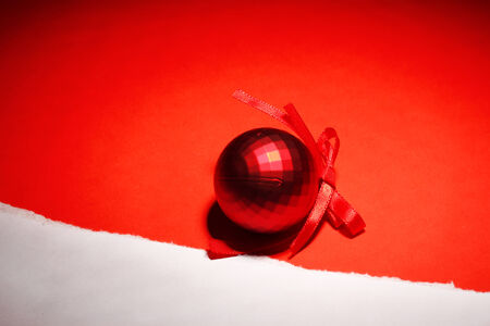 beautiful bright Christmas ball on red backgroundの写真素材