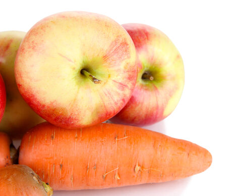 Sweet apples and carrots isolated on whiteの写真素材