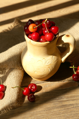 Sweet cherries on wooden table の写真素材