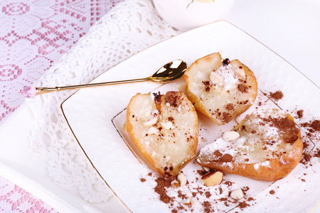 Baked pears with syrup on plate, on bright backgroundの写真素材