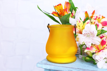 Bright icon-lamp with flowers on wooden stand on light backgroundの写真素材