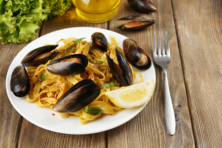 Traditional noodles with mussels on table, close upの写真素材