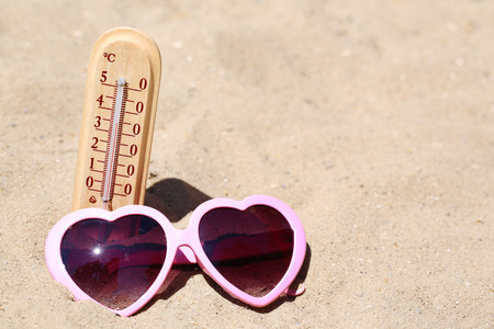 Thermometer in sand close-upの写真素材