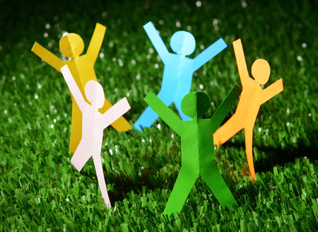 Paper people on green grass, close upの写真素材