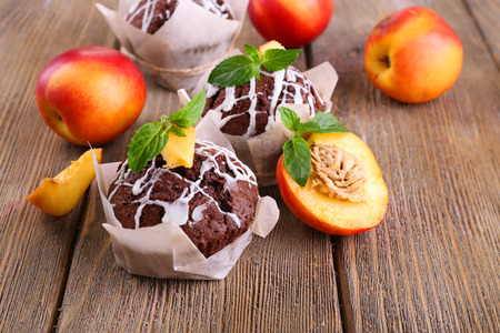 Tasty cupcakes with peach on table close-upの写真素材