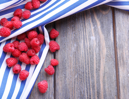 Ripe sweet raspberries on table close-up