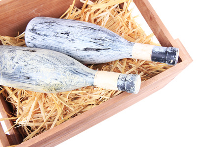 Bottles of wine in wooden box, isolated on whiteの写真素材