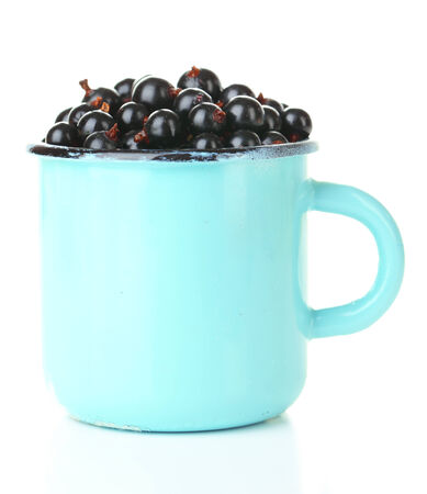 Ripe blackcurrants in mug isolated on white.の写真素材