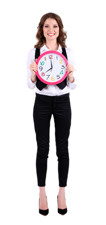 Young business woman with clock isolated on whiteの写真素材