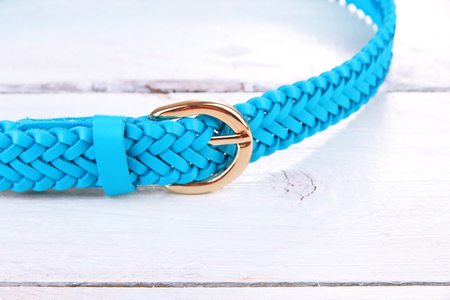 Blue leather belt on wooden backgroundの写真素材