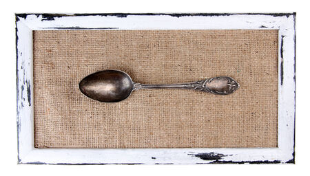 Wooden frame and vintage cutlery  isolated on whiteの写真素材