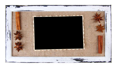 Wooden frame with blank old photo and spices isolated on whiteの写真素材