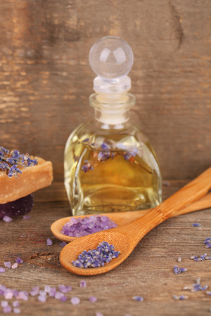 Spa still life with lavender oil and flowers on wooden tableの写真素材