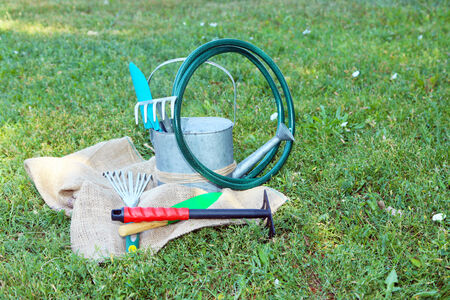 Garden tools on green grass backgroundの写真素材