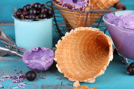 Tasty ice cream with fresh berries on old blue wooden tableの写真素材