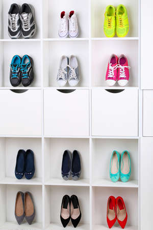 Colorful shoes on wooden shelvesの写真素材