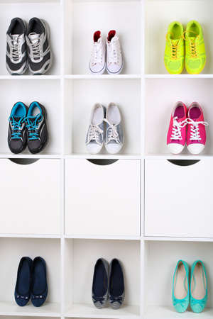 Colorful shoes on wooden shelvesの写真素材