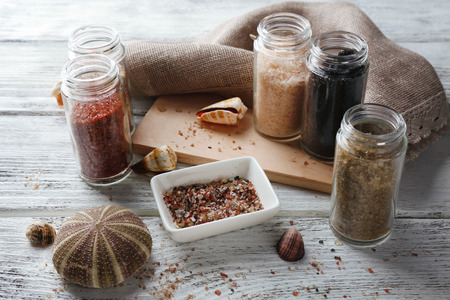 Different sea salt on wooden table, close upの写真素材