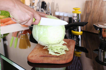 Man cooking in kitchen at homeの写真素材