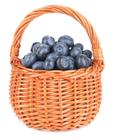 Delicious blueberries in wicker basket isolated on whiteの写真素材
