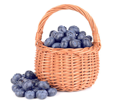 Delicious blueberries in wicker basket isolated on whiteの写真素材