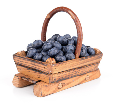 Delicious blueberries in wooden basket isolated on whiteの写真素材