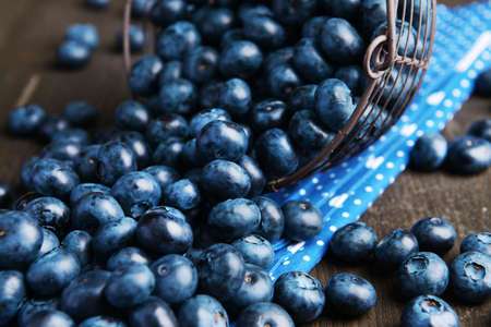 Delicious blueberries in wicker basket on table close-upの写真素材