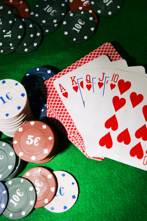Cards and chips for poker on green table