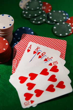 Cards and chips for poker on green tableの写真素材