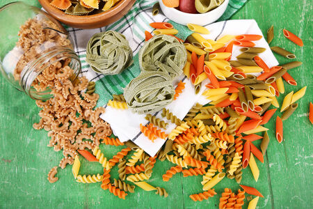 Variety of colorful pasta on wooden backgroundの写真素材