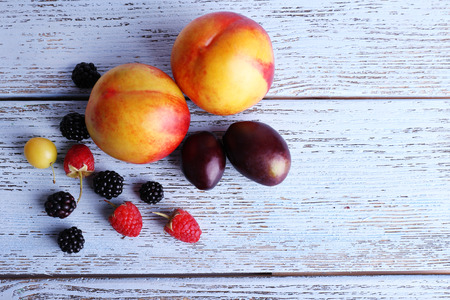 Different berries and fruits on wooden table close-upの写真素材