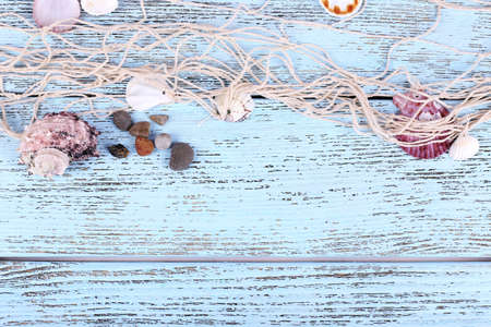 Decor of seashells close-up on blue wooden tableの写真素材