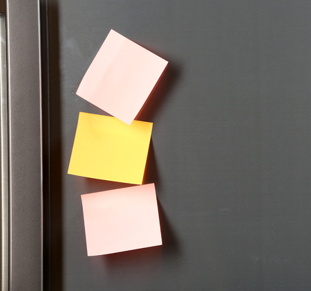Note on piece of paper on refrigerator closeup